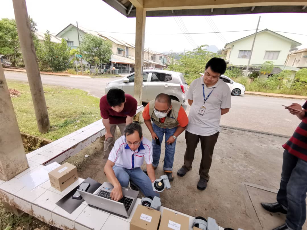 Photo showing Vincent Wong configuring NB-IoT smart meter devices during pilot setup project at Sarawak.